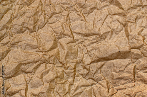 Texture of rough, brown, crumpled paper, closeup.