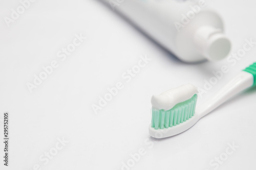 Toothbrush and toothpaste tube on a white background