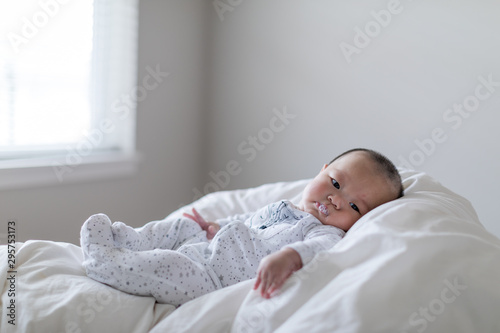 Billede på lærred Little cute baby lying with milk bubble on his mouse