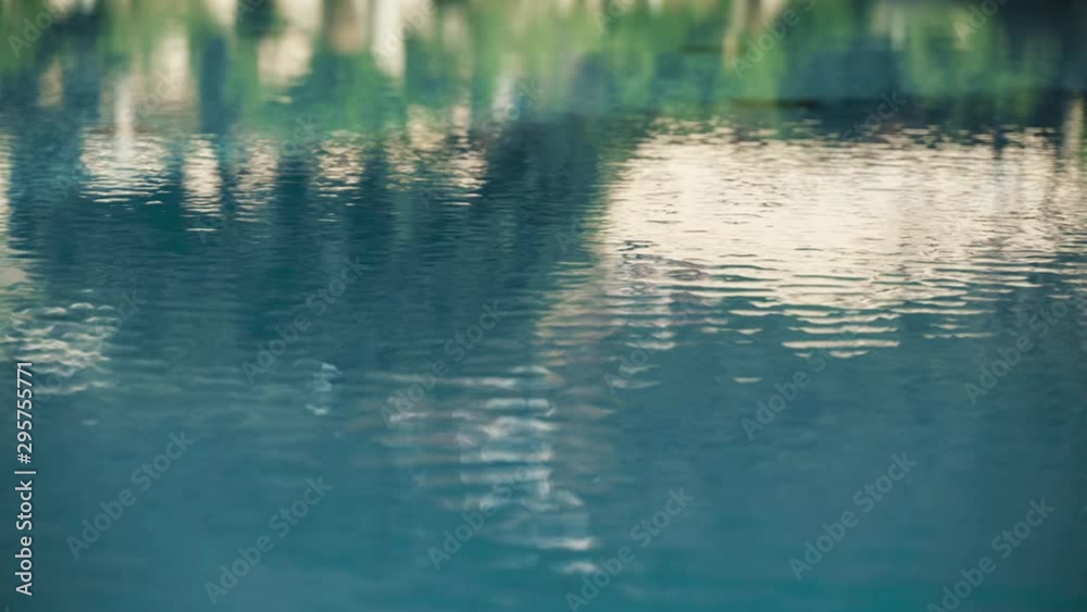 Reflection of house and nature in turquoise blue water swimming pool Reflection of house and nature in turquoise blue water swimming pool