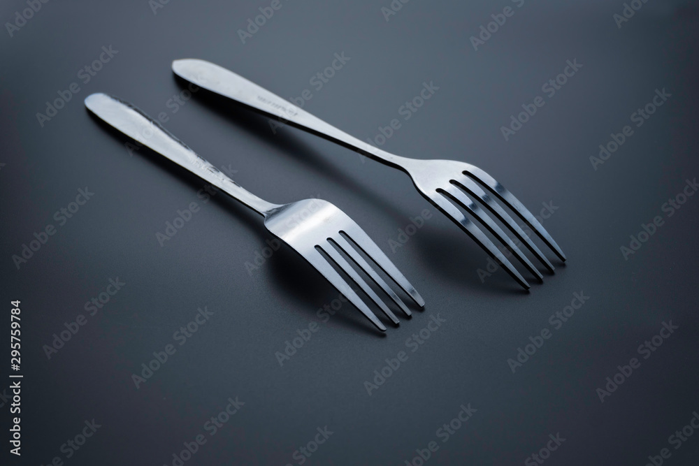 Fork and spoon on dark background, Restaurant concept. soft focus in the middle. Fork and spoon on dark background, Restaurant concept. soft focus in the middle.