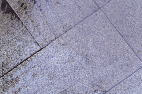 wet tiled sidewalk pavement at rainy day. background, texture.