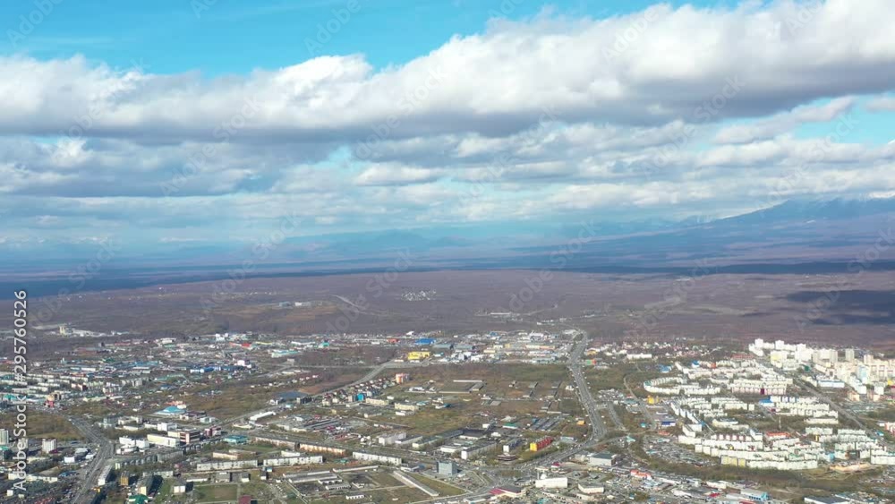 Aerial view of the cityscape overlooking the horizon with mountains Aerial view of the cityscape overlooking the horizon with mountains