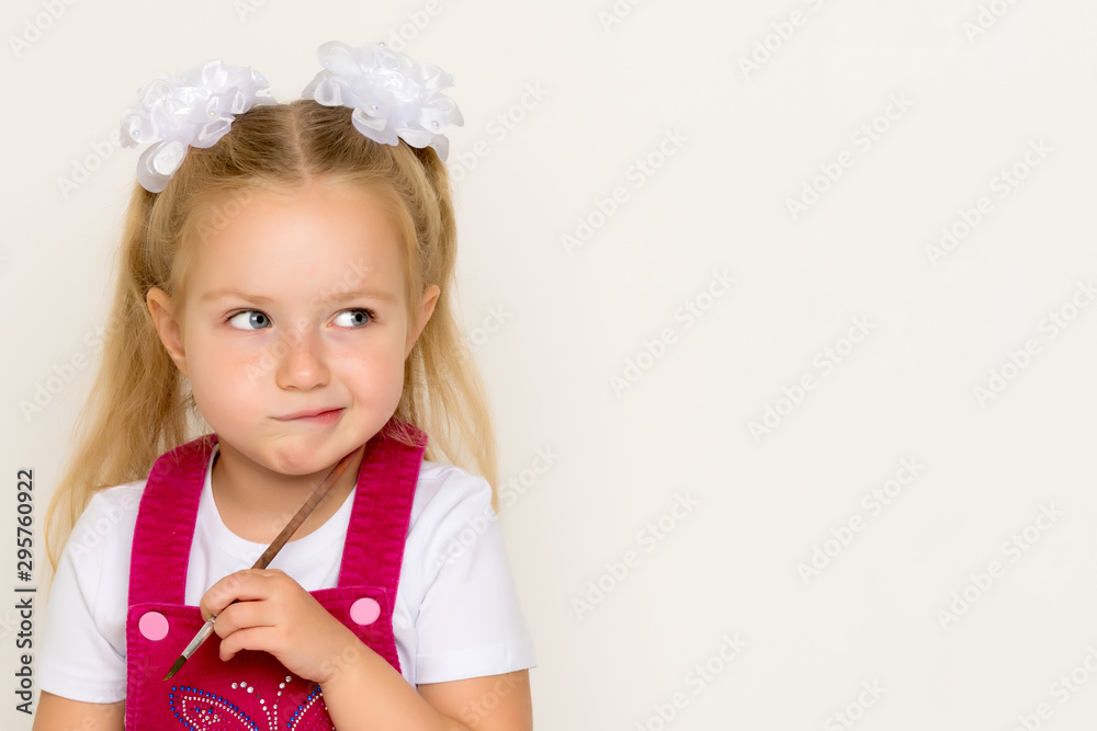 The little girl thinks.Concept kindergarten, montessori education. The little girl thinks.Concept kindergarten, montessori education.