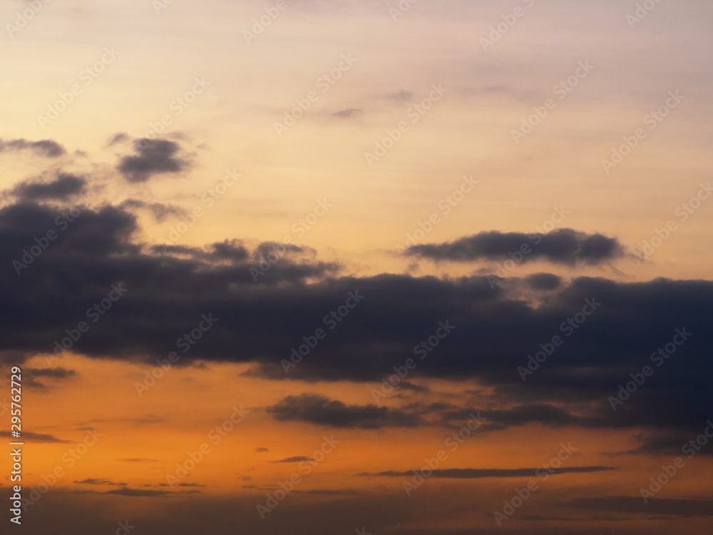 Dark gray clouds on a red sunset sky