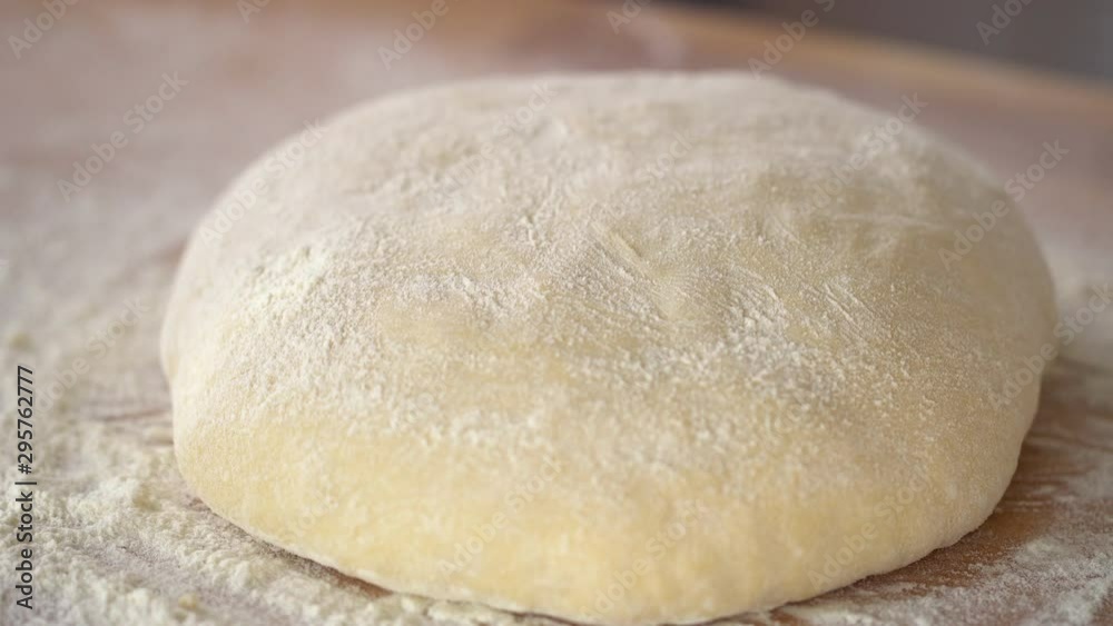 An experienced chef in a professional kitchen prepares the dough with flour to make the bio Italian pasta. the concept of nature, Italy, food, diet and bio. An experienced chef in a professional kitchen prepares the dough with flour to make the bio Italian pasta. the concept of nature, Italy, food, diet and bio.