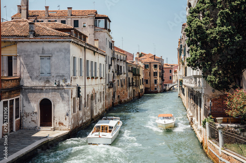 Panoramic view of Venice narrow canal with historical buildings and boats