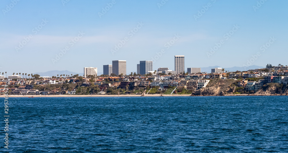 Corona Del Mar beach with city skyline and mountain background in Newport Beach California