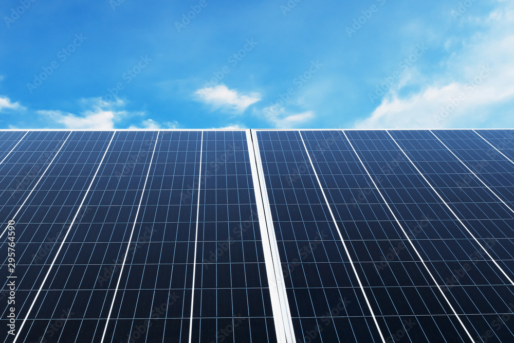 Solar panel with blue sky and sunshine. concept clean energy, electric alternative, power in nature Solar panel with blue sky and sunshine. concept clean energy, electric alternative, power in nature