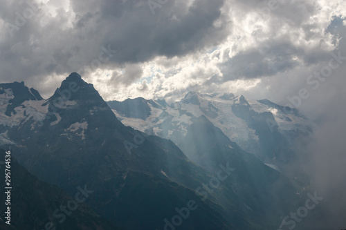 Mountains scene with dramatic cloudy sky in national park of Dombay
