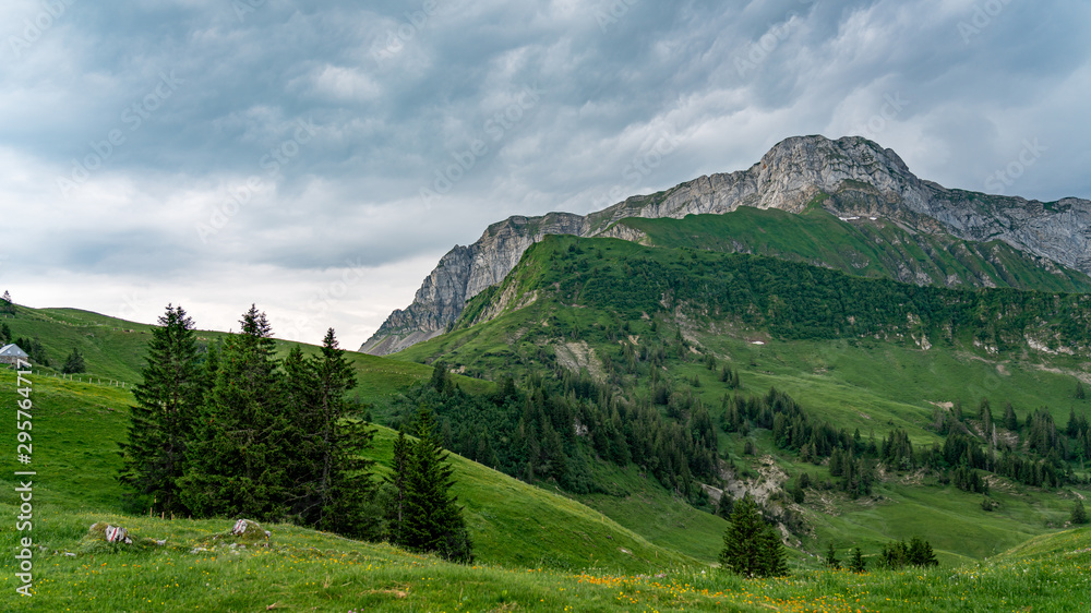 Switzerland, Panoramic view on green Alps and dark clouds from Niederbauen.