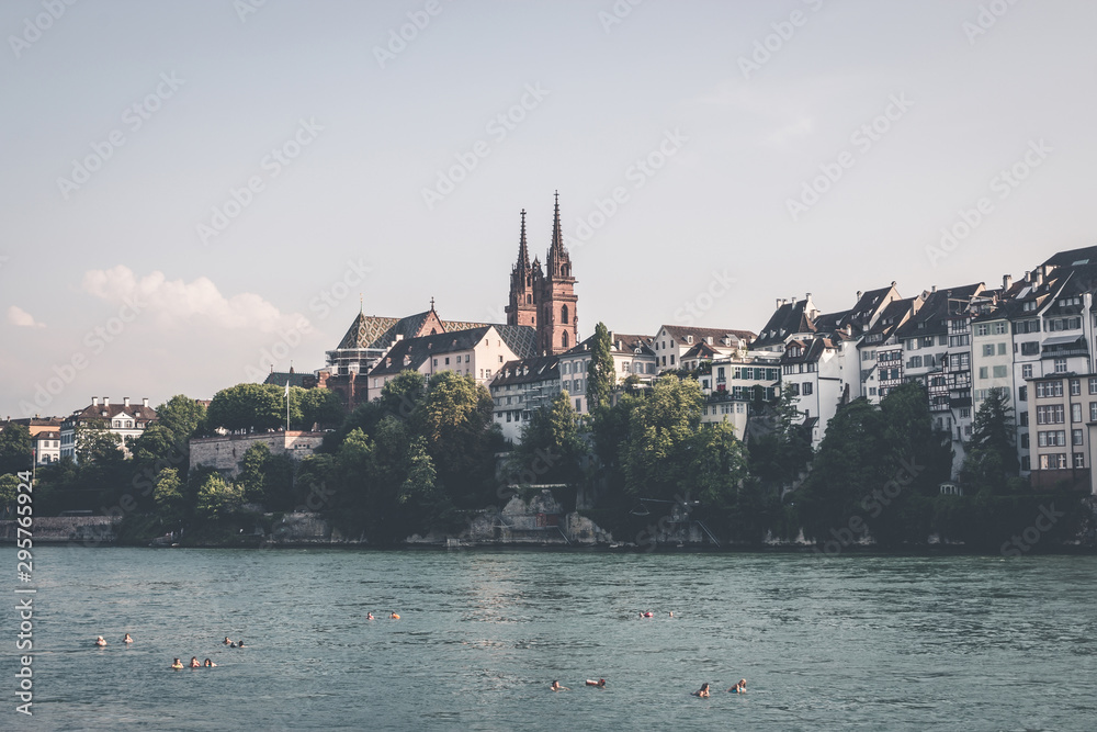 View on Basel city and river Rhine, Switzerland. People swim in water