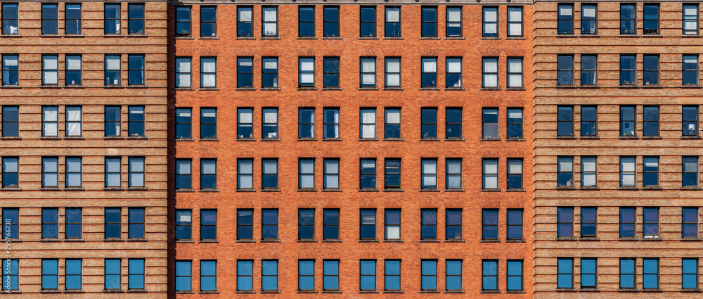 Banner and cover scene of Brown Brick high building facade with windows in New York City, United states of America, USA, Industrial Background and texture, Loft inspiration. Construction facade,