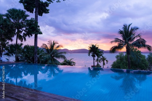 Clear sky when sunset over the sea reflex with swimming pool