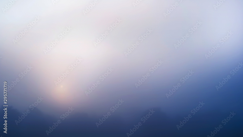 Colored sunrise in forested mountain slope with fog ,View from the mountain in the morning, Surat Thani, Thailand.