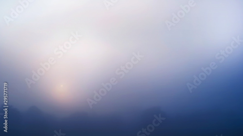 Colored sunrise in forested mountain slope with fog ,View from the mountain in the morning, Surat Thani, Thailand.