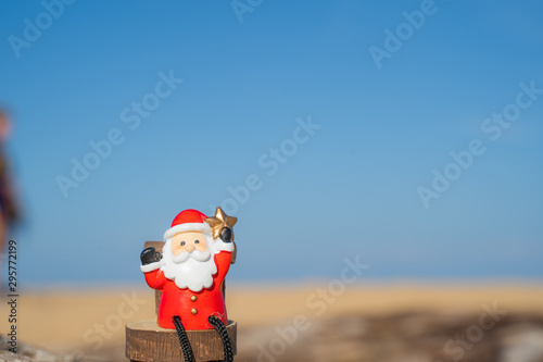 Christmas Santa hold star.on the beach are texture Nature background creative bokeo tropical layout made at phuket Thailand