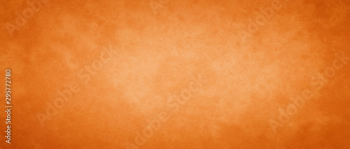 orange autumn background with mottled vintage texture and distressed old texture on the border, halloween or thanksgiving colors