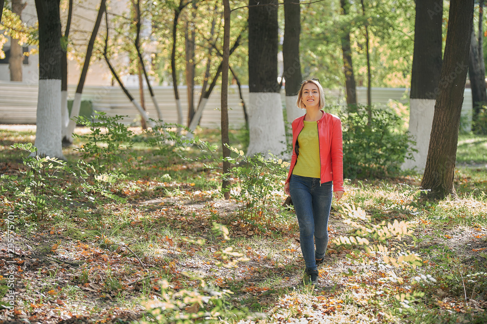 young girl walks in the autumn park young girl walks in the autumn park