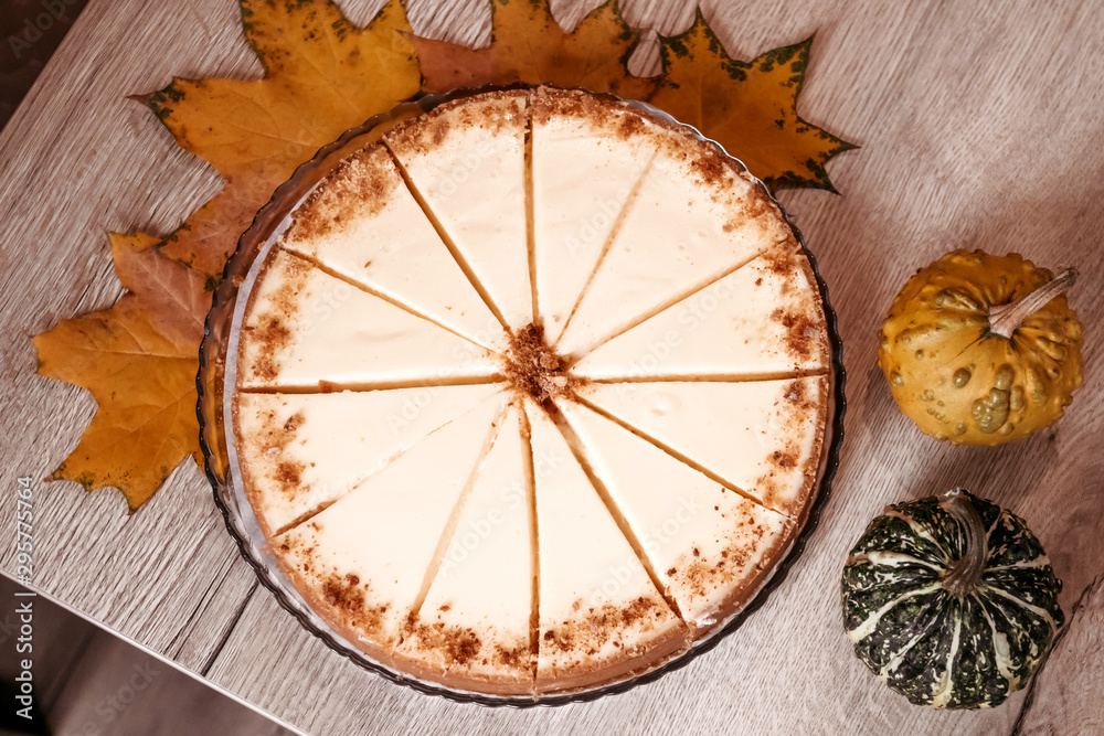 Autumn cheesecake in cafe, pieces of cake on wooden background. Autumn cheesecake in cafe, pieces of cake on wooden background.