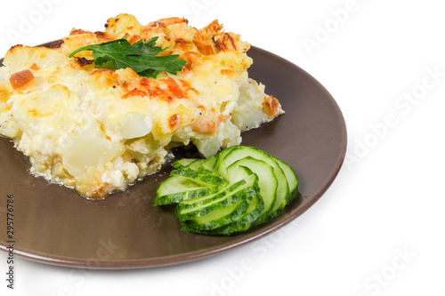 Cauliflower and seafood gratin portion on brown dish close-up