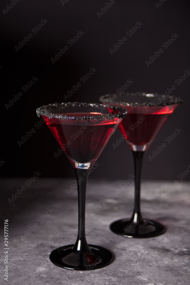 Two glasses with red cocktail for Halloween party on the dark background Two glasses with red cocktail for Halloween party on the dark background