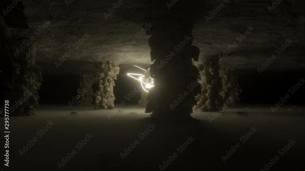 Horrific halloween dark cave vj loop with pillar filled with skull, skulls on foggy floor and animated skull master in center with glowing light. Energic camera move.