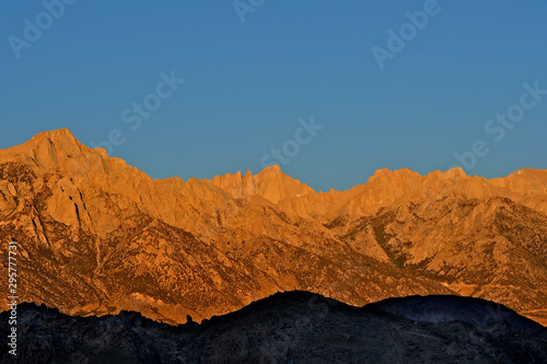 A cloudless Sierra Neveda Crest at sunrise with Alabama Hills in shadow,  Lone Pine, California photo