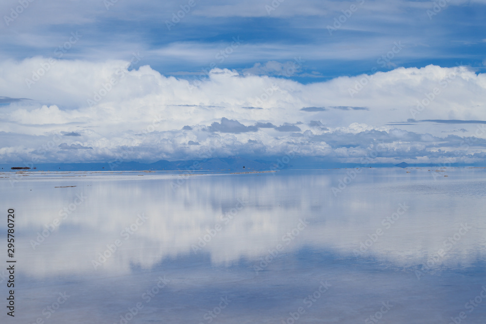 The Salar de Uyuni flooded after the rains, Bolivia. Clouds reflected in the water of the Salar de Uyuni, Bolivia