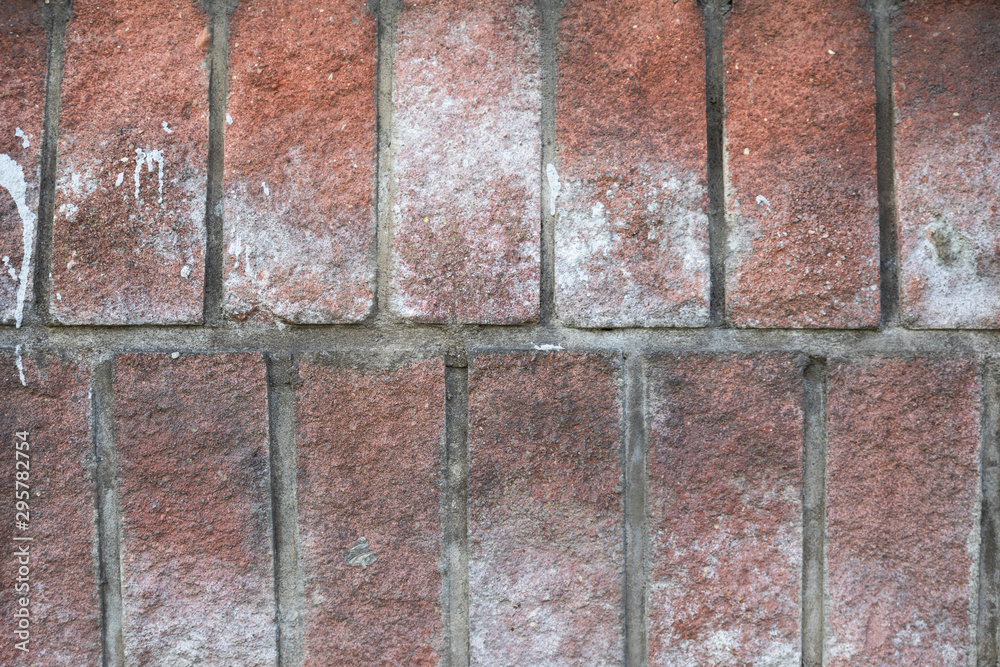 Red cobblestone tile with spots of white paint