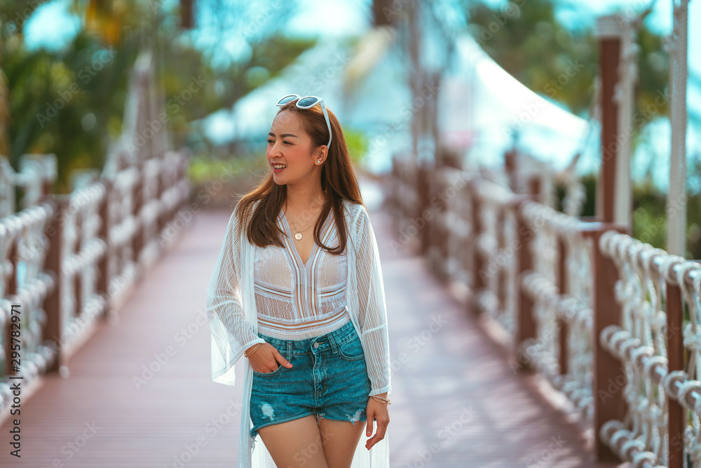 portrait of smile with dress white and jeans in the light outdoor. fashion of smile relax and asian of smile relax holiday and travel with blur background
