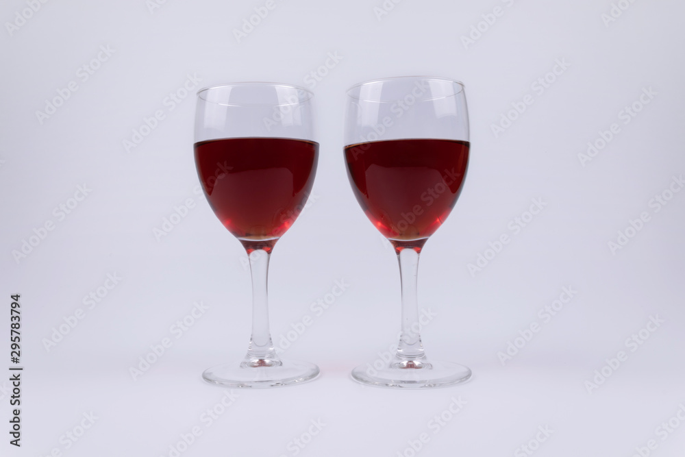 Two isolated glasses full of red wine on white background Two isolated glasses full of red wine on white background