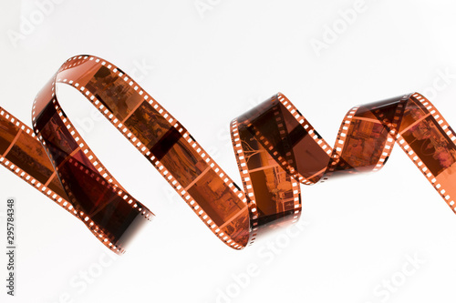 Slightly rolled undeveloped film strip isolated on white background photo