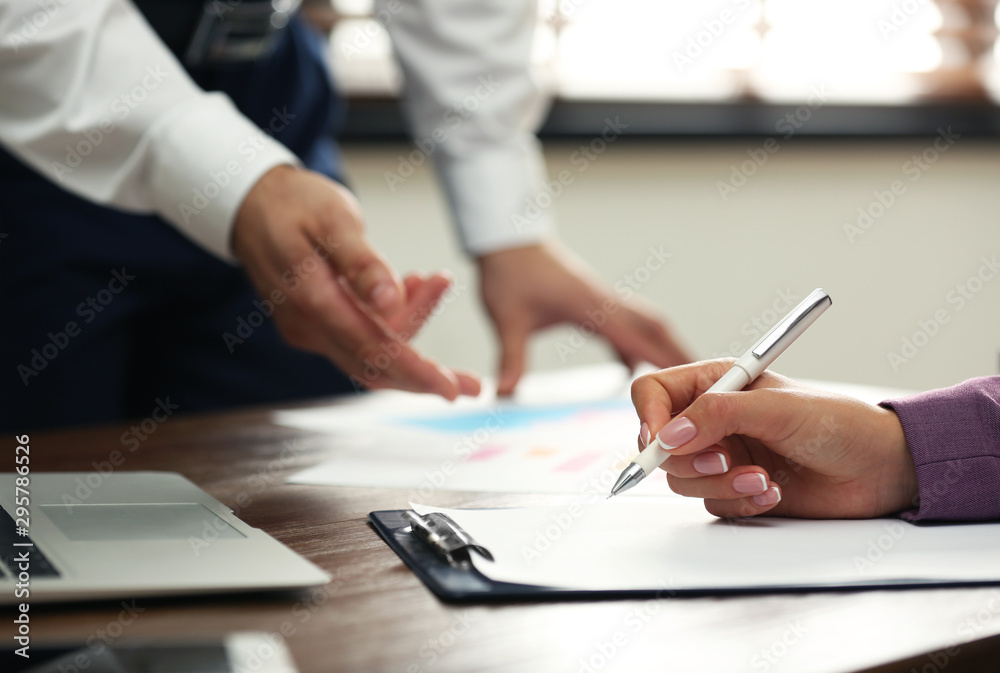 Business trainer and client working at table in office, closeup Business trainer and client working at table in office, closeup