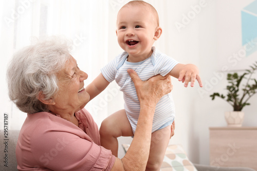 Happy grandmother with little baby at home