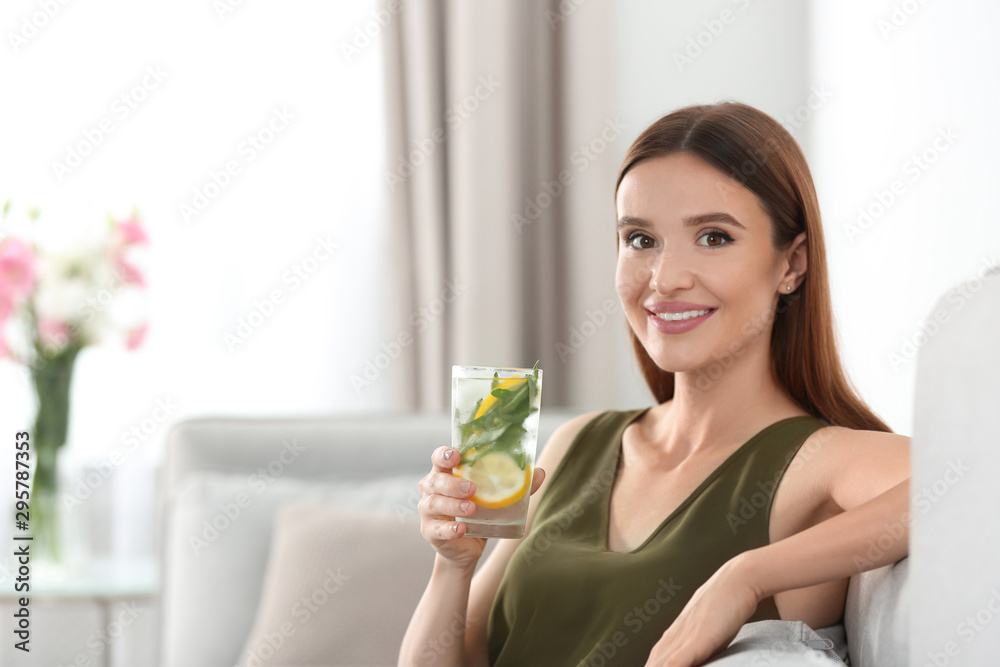Young woman with lemonade at home. Refreshing drink Young woman with lemonade at home. Refreshing drink