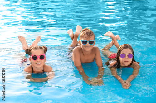 Happy cute children in swimming pool on sunny day © New Africa