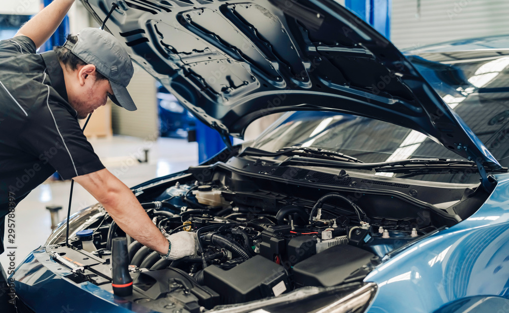 Mechanic man examining and maintenance to customer the engine a vehicle car hood, Safety inspection test engine before customer drive on a long journey, transportation repair service center Mechanic man examining and maintenance to customer the engine a vehicle car hood, Safety inspection test engine before customer drive on a long journey, transportation repair service center