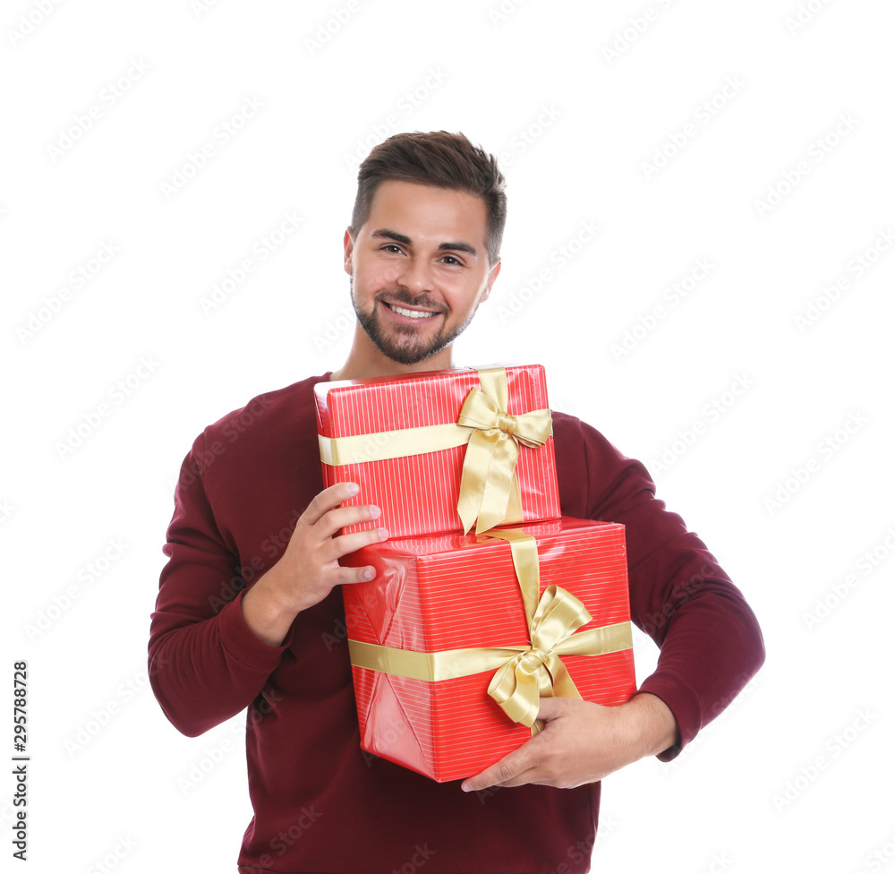 Happy young man holding Christmas gifts on white background Happy young man holding Christmas gifts on white background