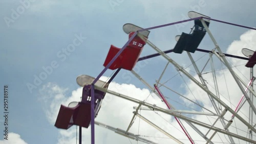 A close up of a Ferris Wheel during a bright summer day. photo