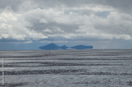 Mirages on the water? Surreal effects in the Salar de Uyuni flooded after the rains, Bolivia. Clouds reflected in the water of the Salar de Uyuni, Bolivia