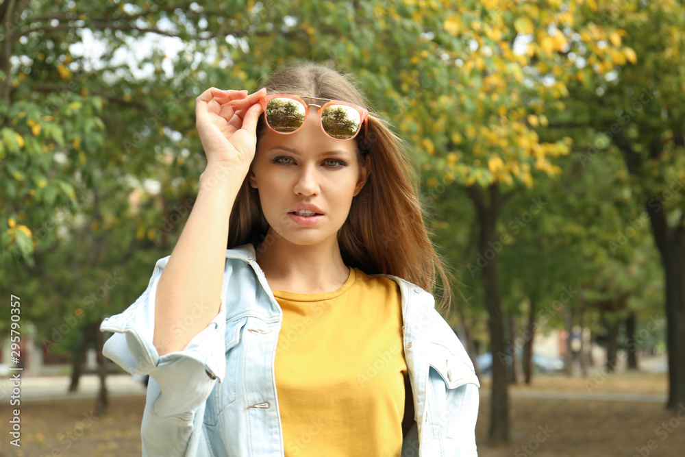 Young woman wearing stylish sunglasses in park Young woman wearing stylish sunglasses in park