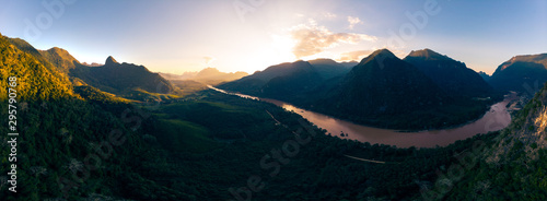 Aerial panoramic Nam Ou River Nong Khiaw Muang Ngoi Laos, sunset dramatic sky, scenic mountain landscape, famous travel destination in South East Asia