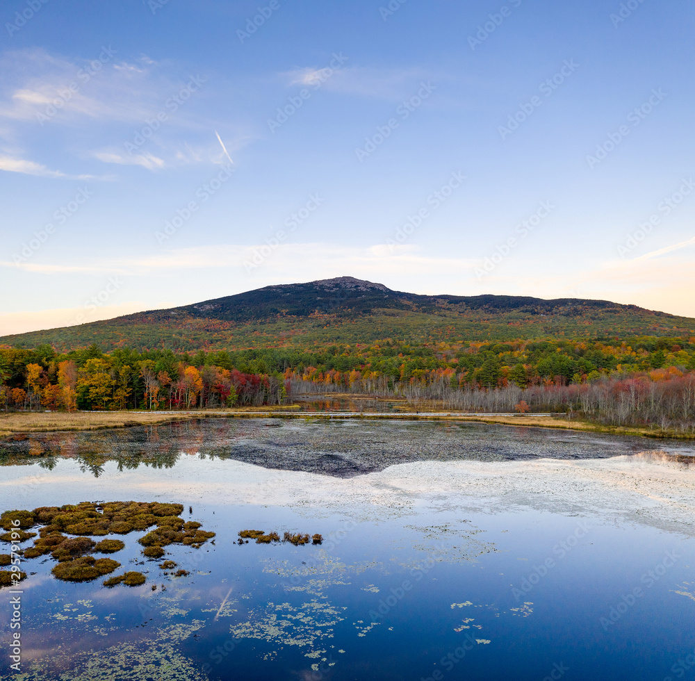 Aerial view of beautiful Mt Monadnock over pond with reflection on water surface Aerial view of beautiful Mt Monadnock over pond with reflection on water surface