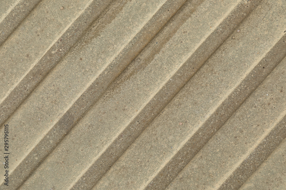 Close-up of beige-grey beton surface with diagonal stripes Close-up of beige-grey beton surface with diagonal stripes