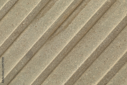 Close-up of beige-grey beton surface with diagonal stripes © Ivan Traimak