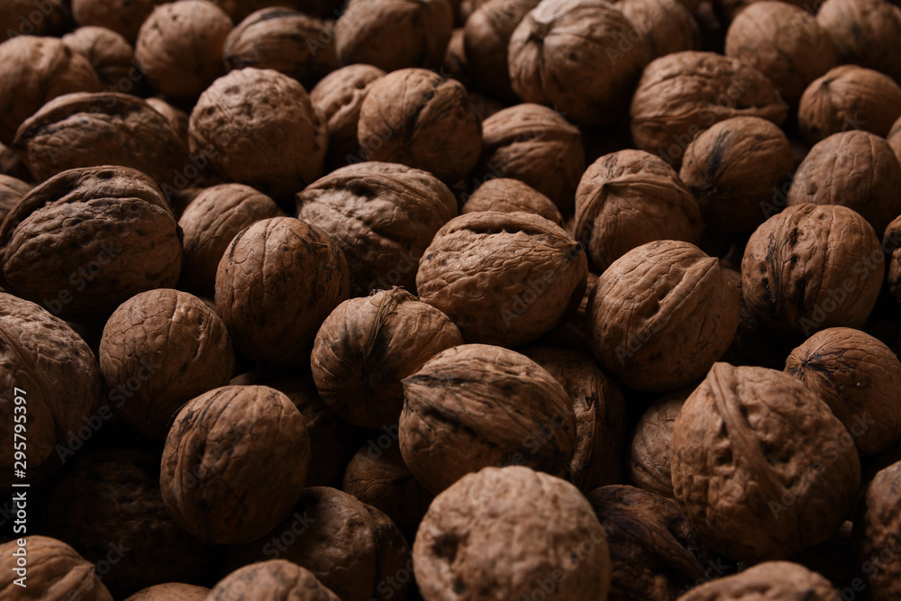 Background of fresh walnuts a lot of relief, closed, in a shell (background, pattern) from a close distance with full frame, copy space and place for text Background of fresh walnuts a lot of relief, closed, in a shell (background, pattern) from a close distance with full frame, copy space and place for text
