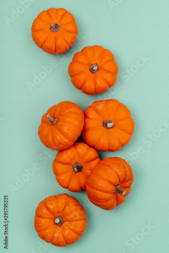 Pumpkins over neo mint background. Autumn, Halloween concept.Copy space for text.