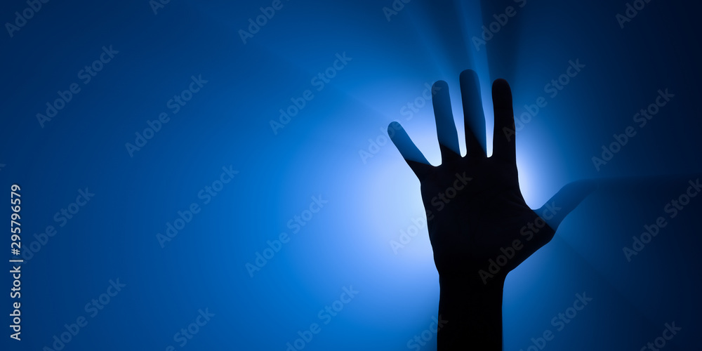 Blue spotlight behind a raised hand