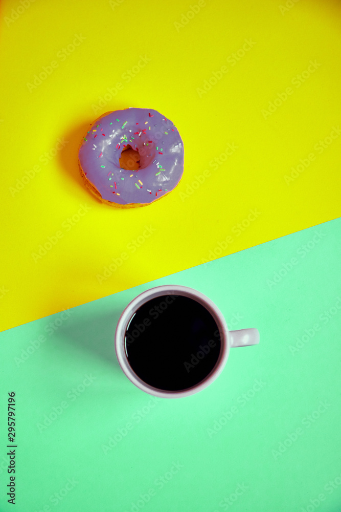 Sprinkled donut and cup of coffee on colorful background. Sprinkled donut and cup of coffee on colorful background.